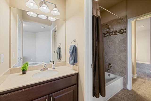 bathroom with shower / tub combo, vanity, and tile patterned floors