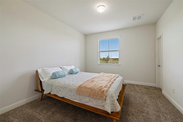 bedroom with dark colored carpet