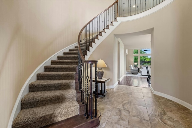 staircase with a towering ceiling