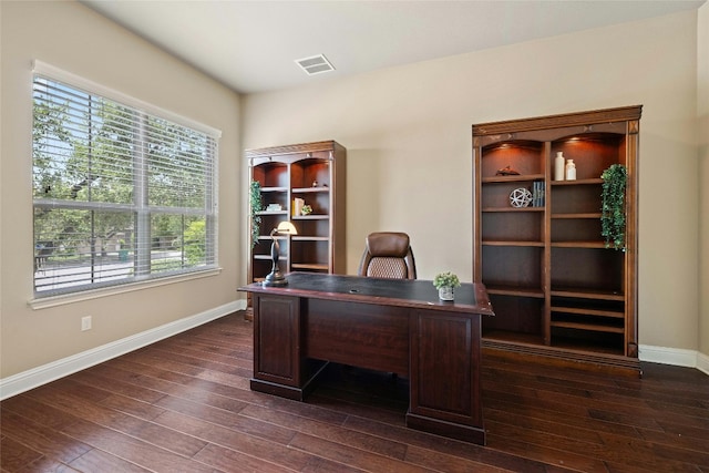 office area with dark hardwood / wood-style floors and a healthy amount of sunlight