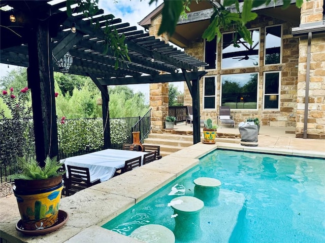 view of swimming pool featuring a pergola, a patio area, and ceiling fan