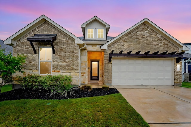 view of front facade with a lawn and a garage