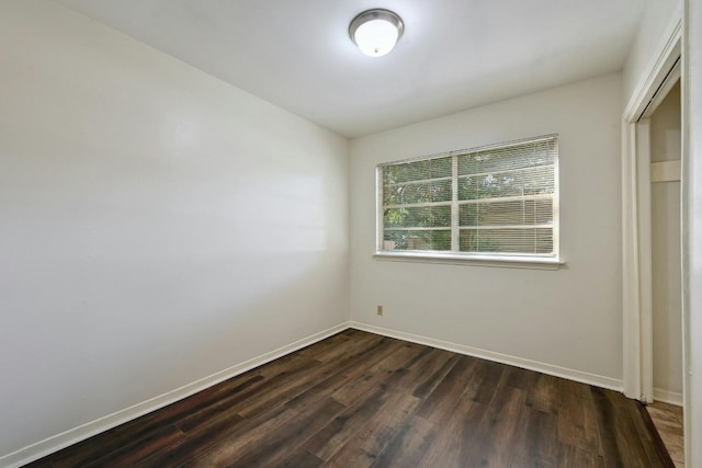 spare room featuring dark hardwood / wood-style flooring