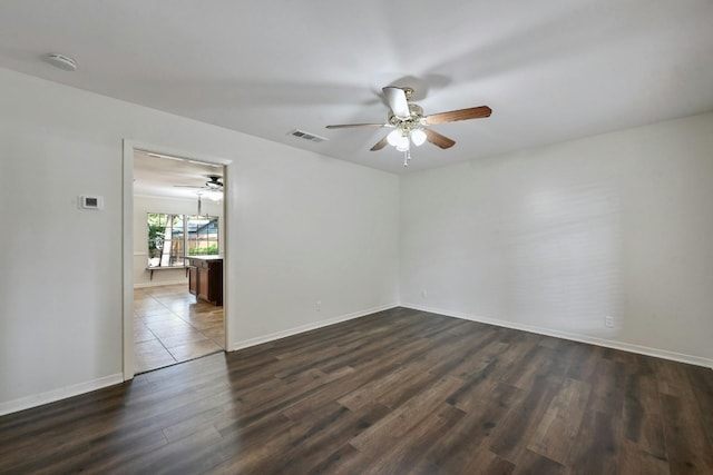 spare room with dark hardwood / wood-style floors