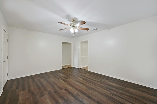 empty room featuring dark hardwood / wood-style flooring and ceiling fan