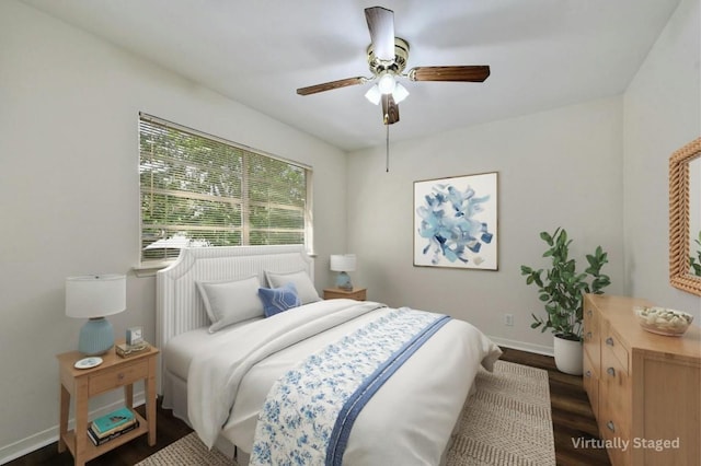 bedroom featuring dark hardwood / wood-style flooring and ceiling fan