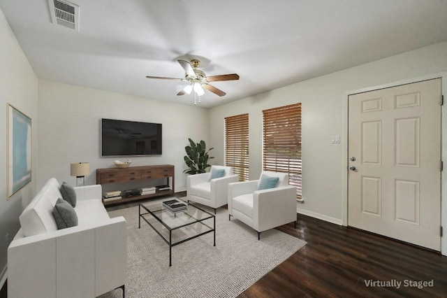 living room with ceiling fan and dark wood-type flooring