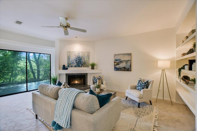 8200 Neely Dr Unit 138, Austin, TX 78759 - carpeted living area with ceiling fan, a tile fireplace, and baseboards