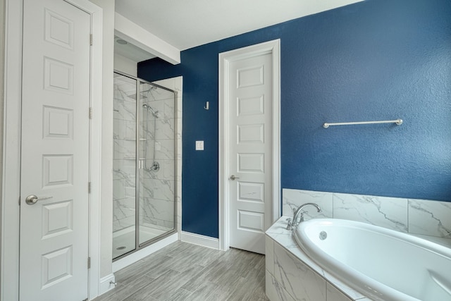 bathroom with hardwood / wood-style floors and independent shower and bath