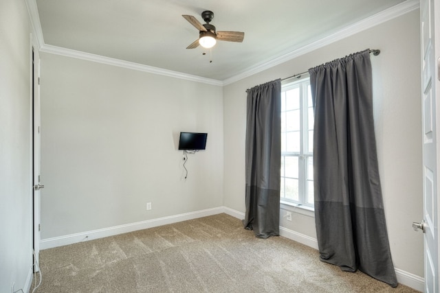 carpeted empty room with ceiling fan and ornamental molding