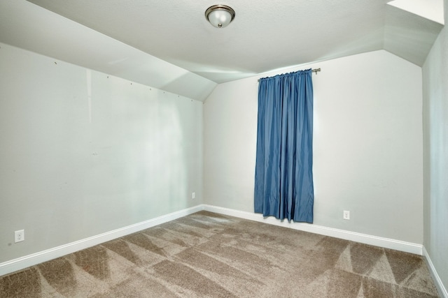 bonus room featuring a textured ceiling, carpet floors, and lofted ceiling