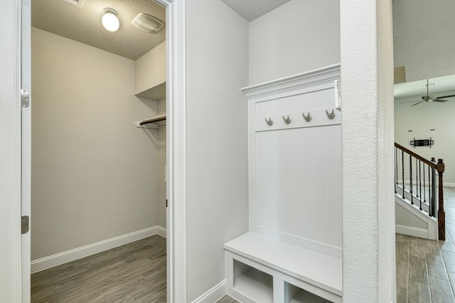 mudroom with ceiling fan and dark wood-type flooring