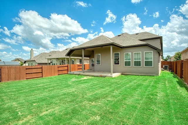 rear view of property with a yard, a patio area, and central air condition unit