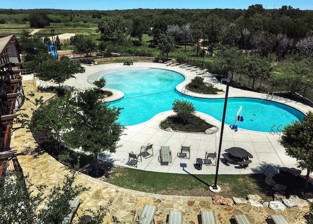 view of swimming pool with a patio