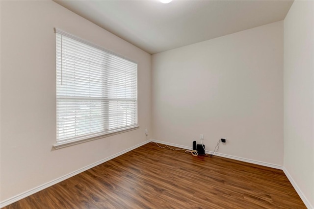 unfurnished room with dark hardwood / wood-style floors