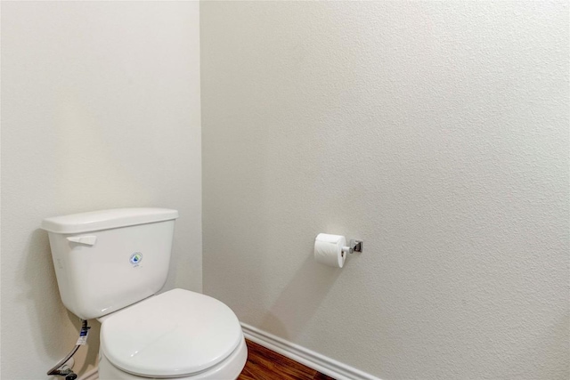 bathroom with hardwood / wood-style floors and toilet