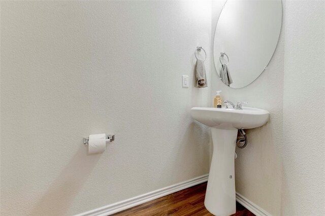 bathroom with hardwood / wood-style floors