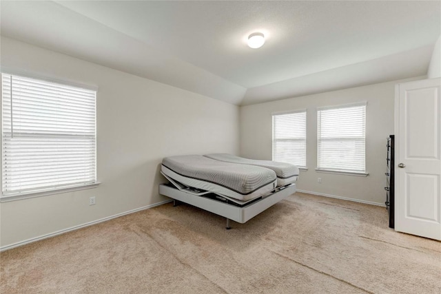 carpeted bedroom featuring lofted ceiling