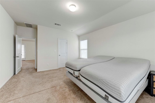 bedroom featuring light carpet