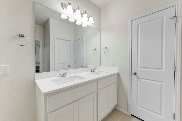 bathroom with tile patterned flooring and vanity