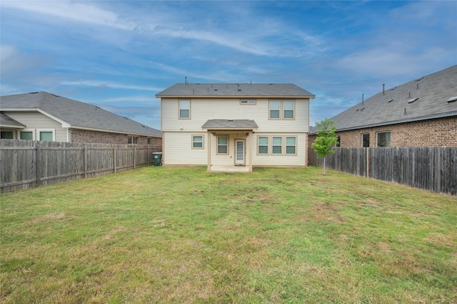 back of property featuring a lawn