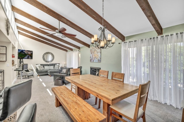 dining area with carpet, lofted ceiling with beams, and ceiling fan with notable chandelier