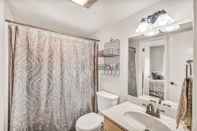 bathroom featuring oversized vanity and toilet