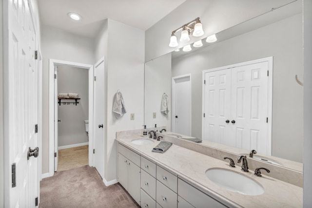 bathroom featuring oversized vanity and dual sinks