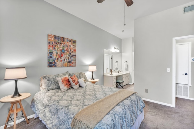 carpeted bedroom featuring ensuite bath and ceiling fan