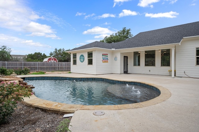 view of swimming pool featuring ceiling fan and a patio area