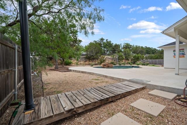 view of yard featuring a patio area and a fenced in pool