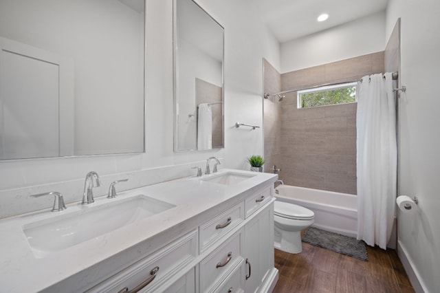full bathroom with toilet, shower / bath combo with shower curtain, wood finished floors, and double vanity