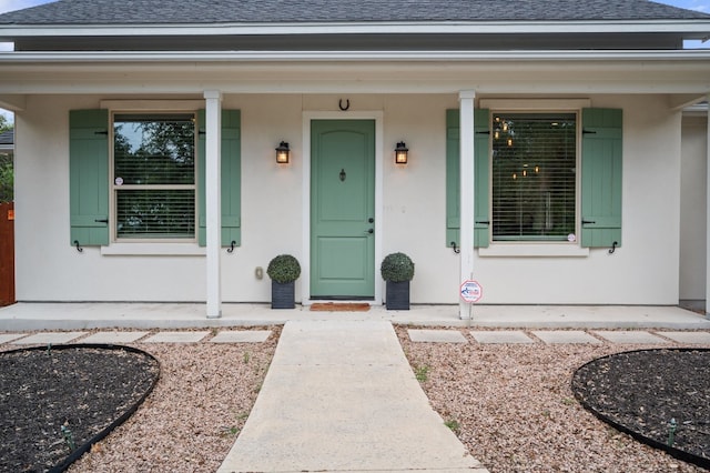 view of exterior entry with covered porch