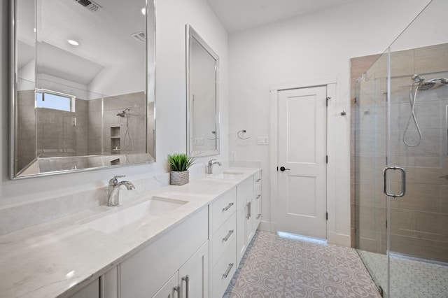 bathroom with lofted ceiling, vanity, and an enclosed shower