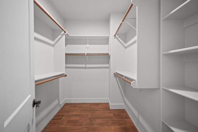 spacious closet with dark hardwood / wood-style floors