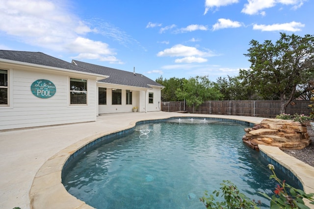 view of swimming pool featuring a fenced backyard and a patio area