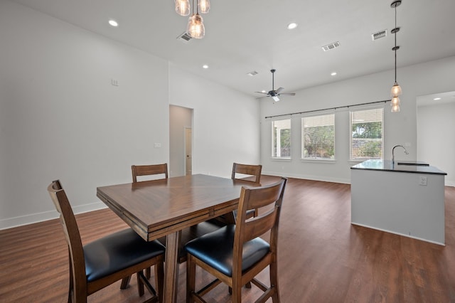 dining room featuring dark hardwood / wood-style floors, ceiling fan, and sink