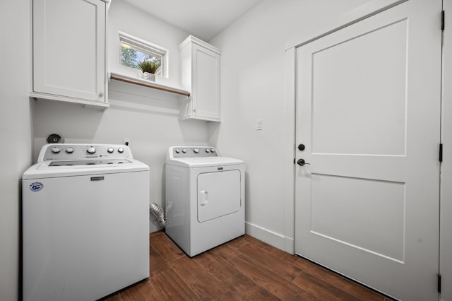 laundry room featuring cabinets, washing machine and dryer, and dark wood-type flooring