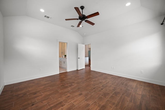 spare room featuring ceiling fan, dark wood-type flooring, and vaulted ceiling