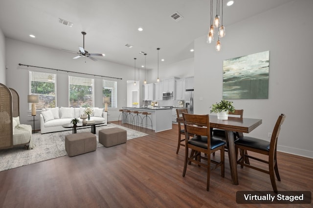 dining space with dark hardwood / wood-style floors and ceiling fan