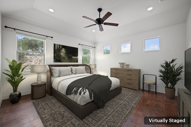 bedroom featuring multiple windows, ceiling fan, and dark hardwood / wood-style flooring