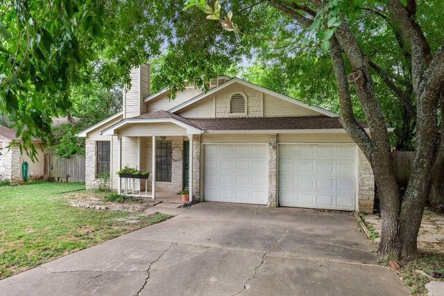 view of front facade with a garage, covered porch, and a front lawn