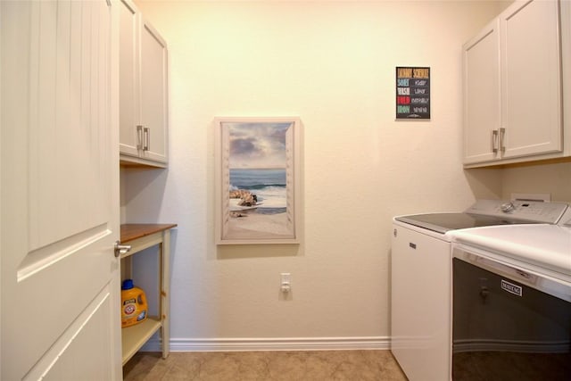 washroom featuring cabinets and independent washer and dryer