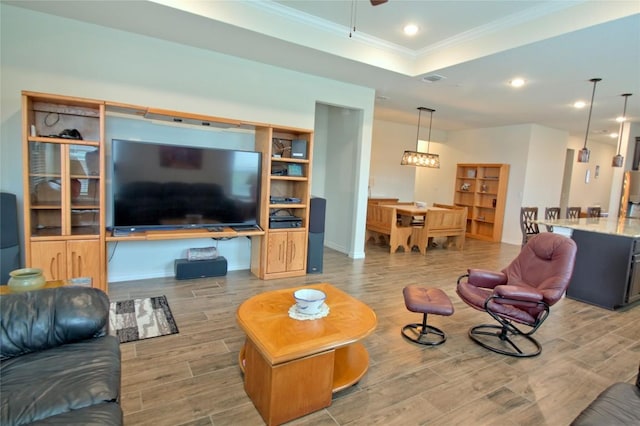 living room featuring a tray ceiling and crown molding