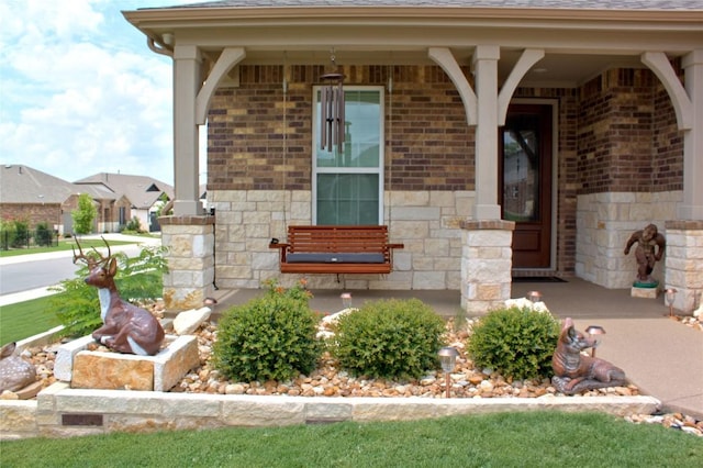 view of exterior entry with covered porch