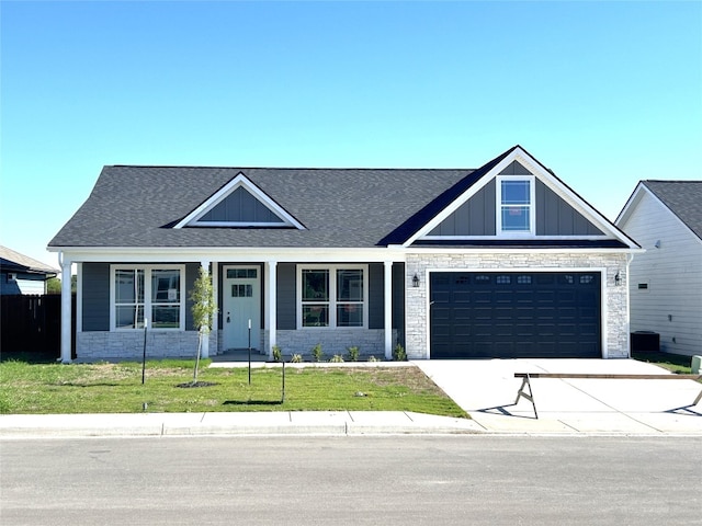 view of front of house featuring a garage and a front lawn