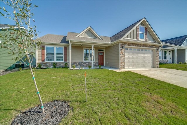 craftsman-style house with a front yard and a garage