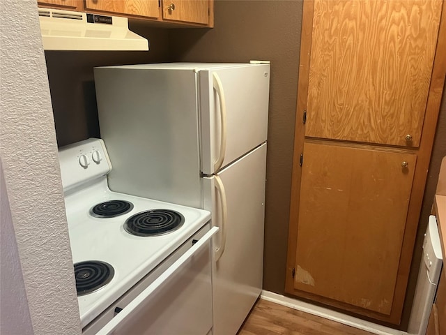 kitchen featuring range hood, hardwood / wood-style flooring, and white electric range oven