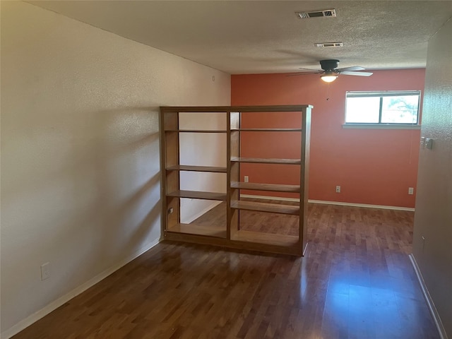 unfurnished bedroom featuring dark hardwood / wood-style floors and ceiling fan