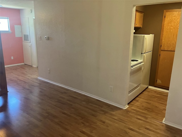 kitchen featuring hardwood / wood-style flooring and white appliances